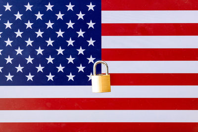 Close-up of flags against blue wall