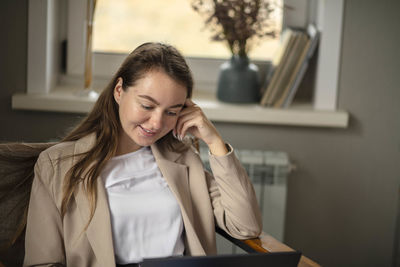 Businesswoman using her laptop in office. small business entrepreneur.