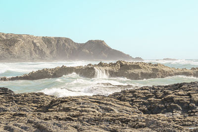 Scenic view of beach against clear sky