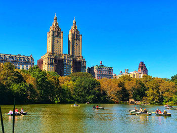 Boats in river against buildings