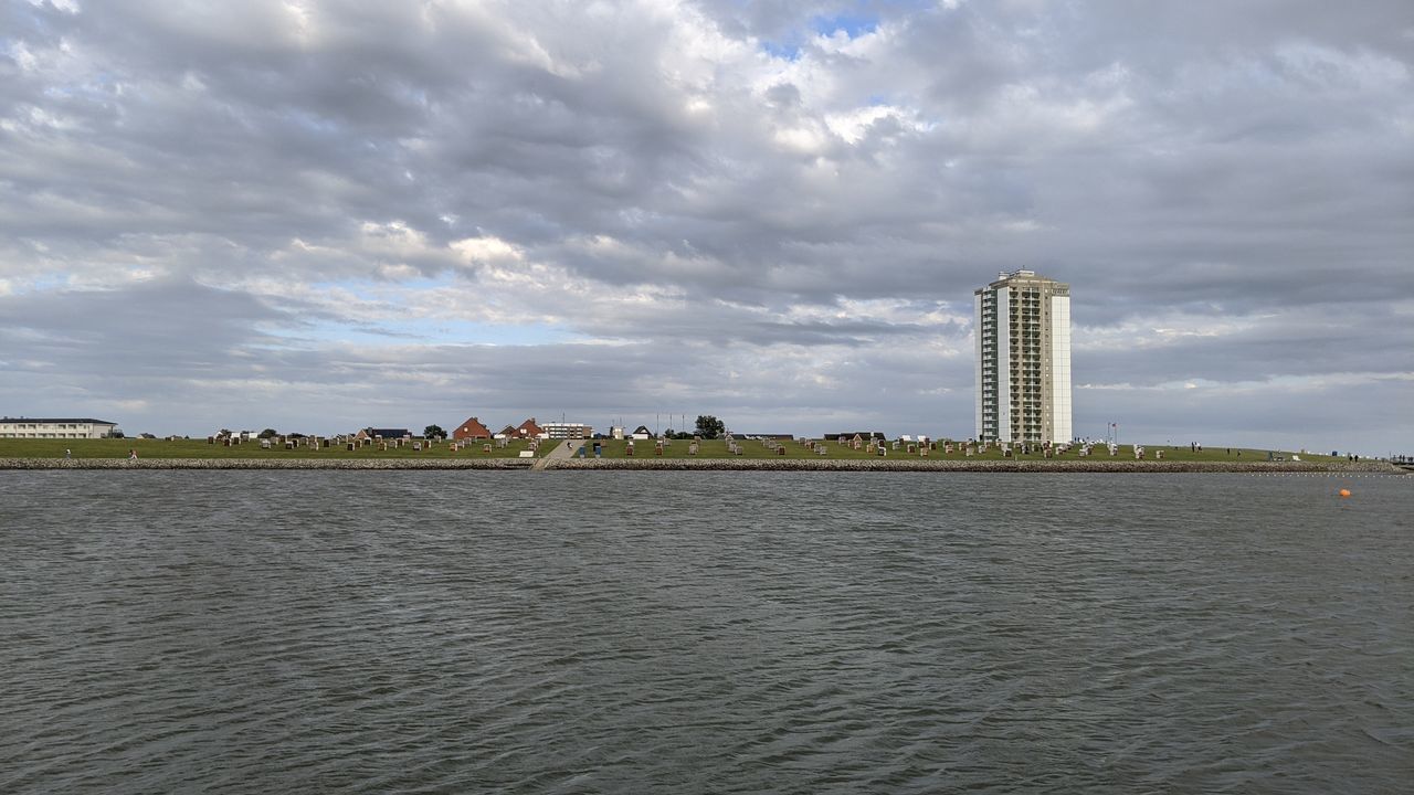 SEA AND BUILDINGS AGAINST SKY