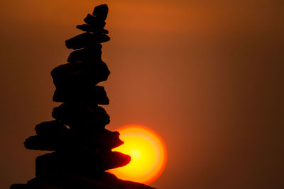 Low angle view of silhouette statue against sky during sunset