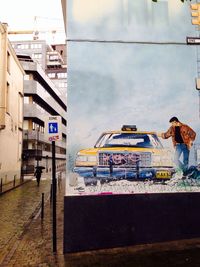 Buildings in city against cloudy sky