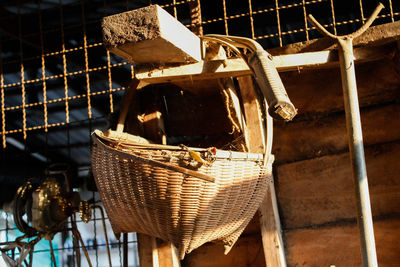 Close-up of abandoned basket hanging on wood