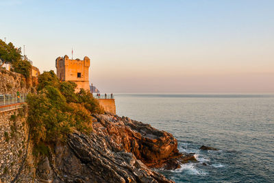 The gropallo tower on the cliff of the anita garibaldi promenade at sunset, nervi, genoa, liguria