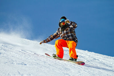 Low angle view of person snowboarding