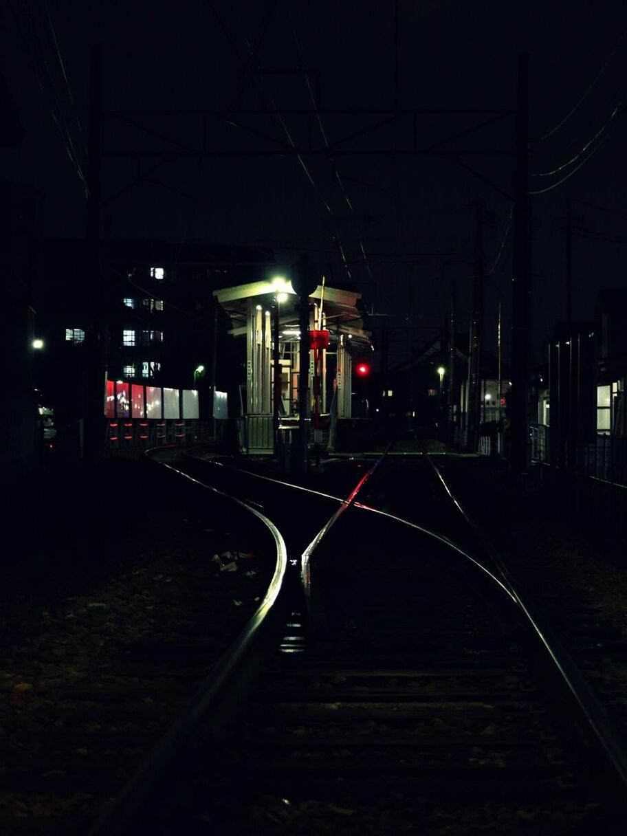 railroad track, transportation, illuminated, night, rail transportation, the way forward, railroad station platform, public transportation, railroad station, street light, diminishing perspective, empty, mode of transport, train - vehicle, vanishing point, lighting equipment, absence, dark, no people, built structure