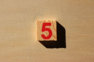 Close-up of number 5 on wood