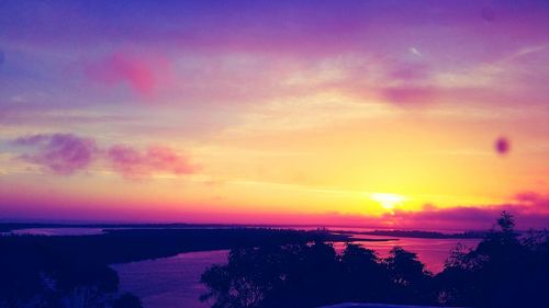 Scenic view of sea against sky at sunset