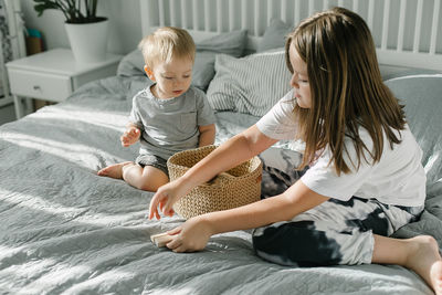 Women sitting on bed at home