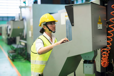 Female engineer working in factory