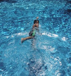 High angle view of boy swimming in pool