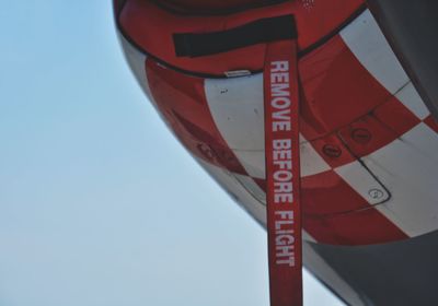 Low angle view of sign against clear sky