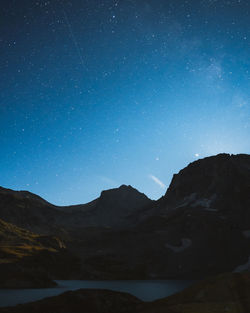 Scenic view of mountains against sky at night