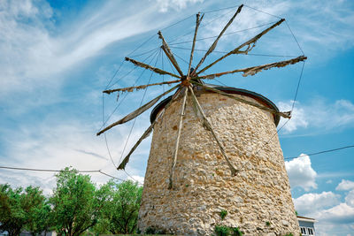 Low angle view of traditional windmill against sky