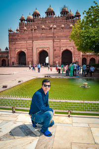 Man sitting on historical building