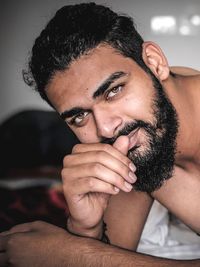 Close-up portrait of shirtless young man