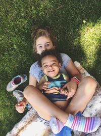 High angle view of siblings playing on grass