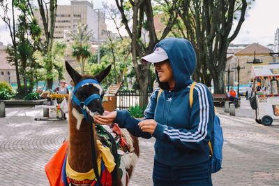 Full length of man standing on street in city