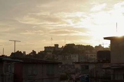 Buildings in city at sunset