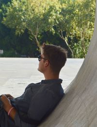 Rear view of young man looking at camera