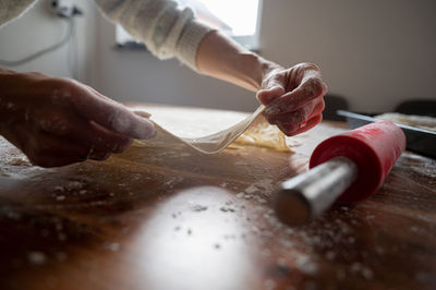 Midsection of person preparing food on table