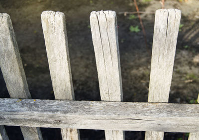 Old gray wooden fence from the cracked boards.