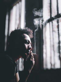 Portrait of man smoking cigarette