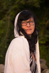 Portrait of beautiful woman with hood at sunrise light