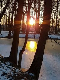 Scenic view of snow covered landscape at sunset