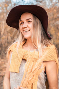 Portrait of a smiling young woman wearing hat