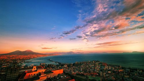 Aerial view of townscape against sky at sunset