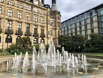 View of fountain against sheffield townhall building