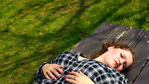 High angle view of man lying on grassy field