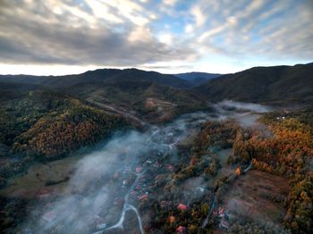 Scenic view of mountains against cloudy sky