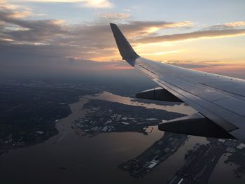 Cropped image of airplane flying over clouds