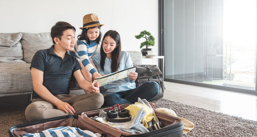 Young couple sitting on sofa at home