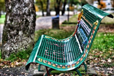 Close-up of empty bench in park