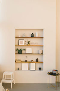 Stylish shelves in the living room wall, on which there is a decor for christmas and new year