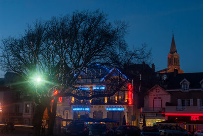 Illuminated buildings against sky in city at night