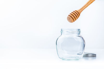 Close-up of empty bottle on table against white background