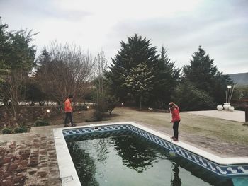 Silhouette of woman standing on tree