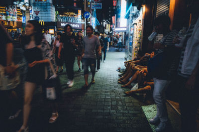 People walking on road in city at night