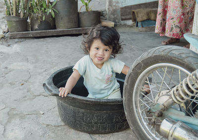 High angle view of cute girl sitting on street