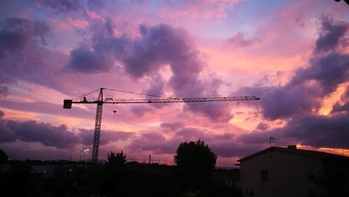 Silhouette of city against dramatic sky