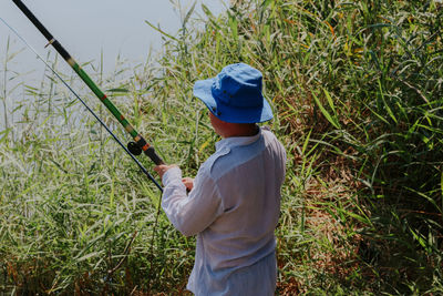 One young man catches fish with a fishing rod.