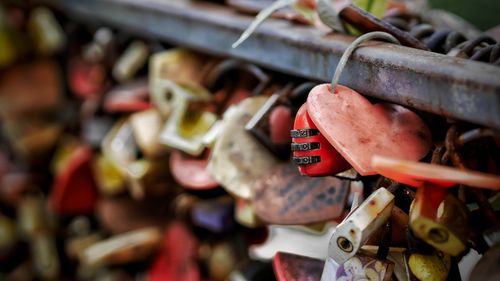 Close-up of padlocks hanging on railing