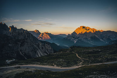 Scenic view of snowcapped mountains against sky during sunset