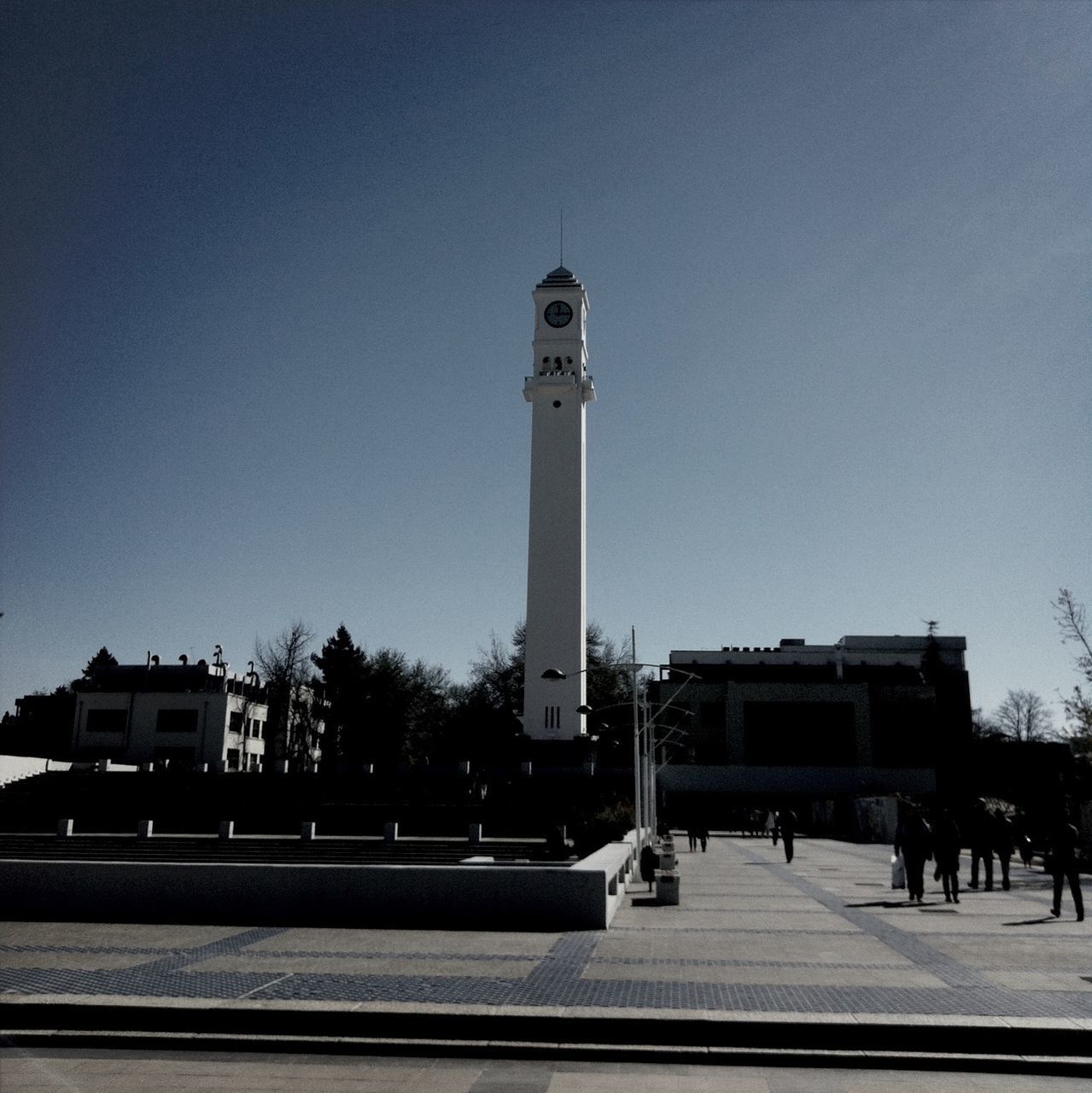 architecture, building exterior, built structure, clear sky, transportation, street, road, car, land vehicle, street light, copy space, low angle view, guidance, city, tower, mode of transport, incidental people, sky, outdoors, day