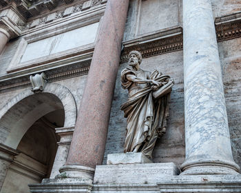 Low angle view of statue against temple